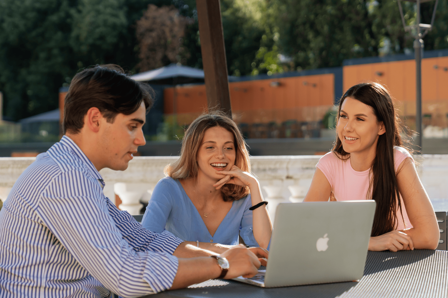 Students checking the screen of a laptop